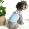 Poodle wearing Pretty Summer Adjustable Dog Dress with a pink and white striped T-shirt pretty fluffy flower on adjustable strap and green leaf sown on pocket and Lead attachment, from Puppy Clothes